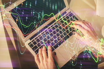 Double exposure of woman hands working on computer and forex chart hologram drawing. Top View. Financial analysis concept.