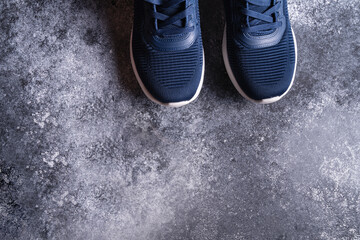 Fitness equipment with sneakers on gray background, top view. Copy space for text.