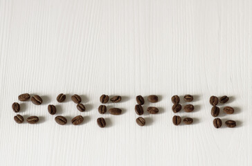 word coffee made from coffee beans on white background