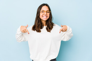 Young mixed race hispanic woman isolated points down with fingers, positive feeling.