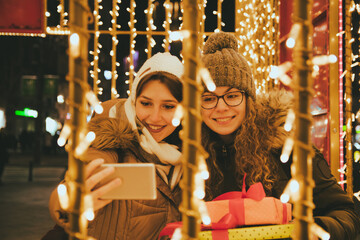 Two female friends making Christmas selfie