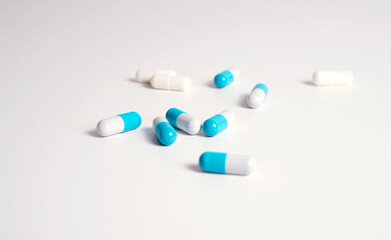 White and bleu medical pills on white background