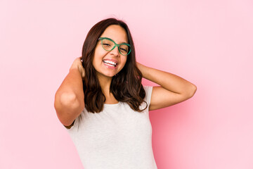 Young mixed race hispanic woman isolated feeling confident, with hands behind the head.