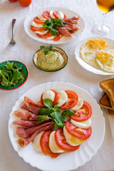 table for two: caprese salad with guacamole sauce and tomato
