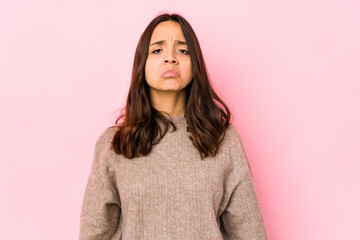 Fototapeta premium Young mixed race hispanic woman isolated sad, serious face, feeling miserable and displeased.