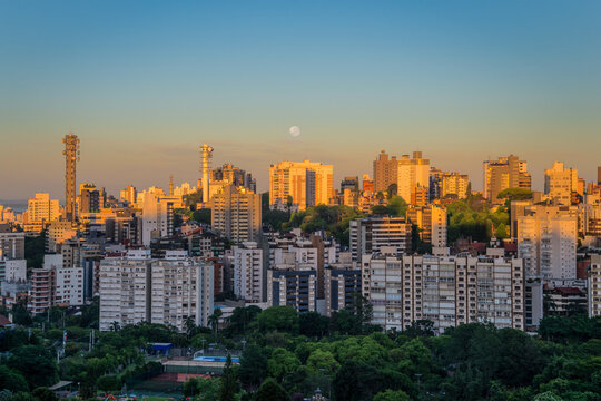 Porto Alegre skyline with buildings partially illuminated by the sun. City located in the South of Brazil.  Cityscape during sunrise.