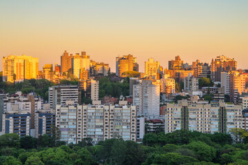 Porto Alegre skyline during sunrise with buildings partially illuminated. City located in the South of Brazil. 