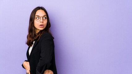 Fototapeta premium Young mixed race hispanic woman isolated looks aside smiling, cheerful and pleasant.