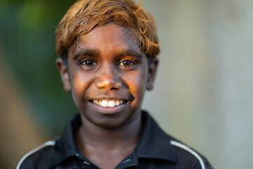 school-aged boy head and shoulders with blurry background