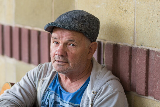 Older man wearing Yorkshire cap, looking at camera