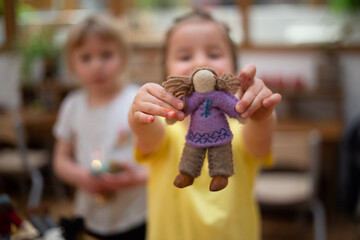 Child holding international felt doll