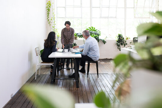 Three people collaborating in an open office