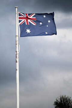 Australian Flag against a dark cloudy sky