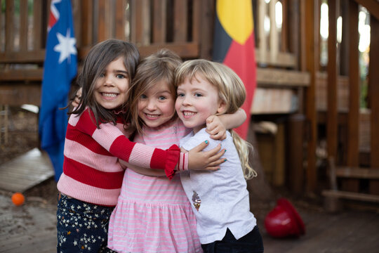 Early education, three girls hugging