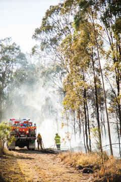 NSW Rural Fire Service Volunteer Firefighter Beside Truck In Fire Smoke