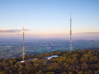 Aerial view of two large antennae on the top of a hill
