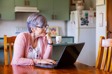 Middle aged woman using online banking from her laptop