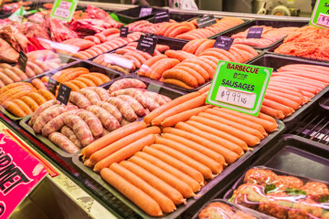 A display of sausages on trays in a market