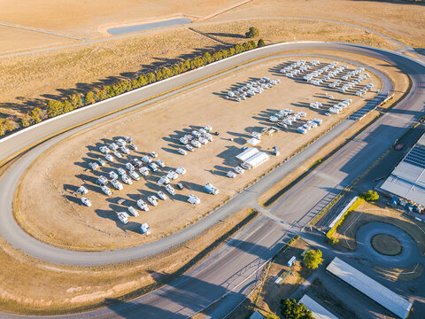 Aerial view of dozens of motor homes parked at a racetrack