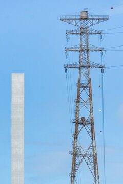 Large electricity stanchions and power cables running over a bridge
