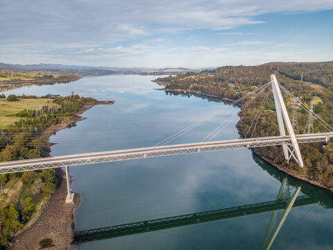 Aerial view of a modern bridge spanning a wide river