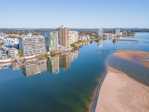Aerial view of apartment buildings along the sides of the Maroochy River .