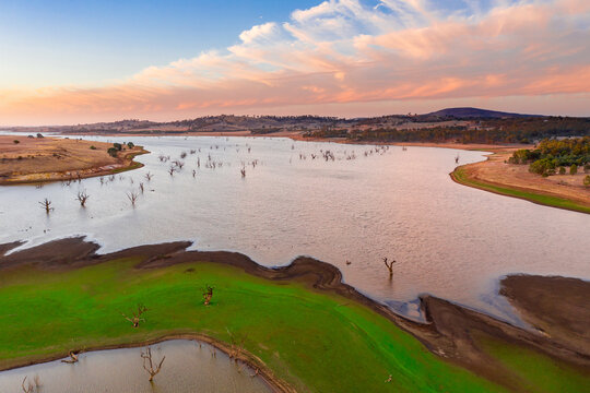 Aerial view of a drying reservoir at sunset.