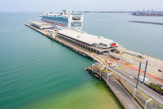 Aerial view of a large cruise ship docked at shipping terminal