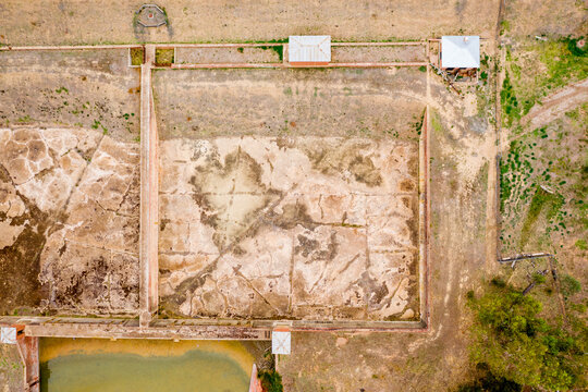 Aerial view of disused settling ponds with muddy bottoms