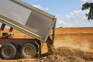 truck tipping soil on a construction site