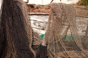 colorful texture of fishing nets and weathered boat