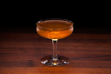 Brooklyn cocktail on a walnut bar top (Rye Whiskey, Dry Vermouth, Maraschino Liqueur)