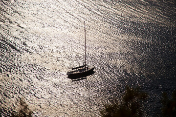 silhouette sailing boat view on the shimmering sea