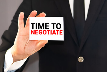 Time to negotiate words on a card in businessman's pocket. Compromise in business concept.
