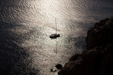 silhouette sailing boat view on the shimmering sea