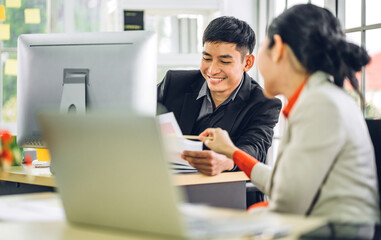 Two business people working and discussing strategy with laptop computer.creative business people planning and brainstorm in modern work loft.Teamwork concept