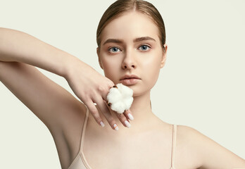 Beautiful young woman with clean perfect skin with cotton
