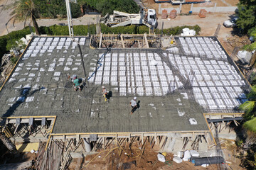 Pouring concrete,  commercial concreting floors of buildings in construction. Boom pump pouring...