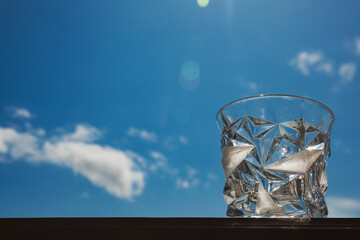 Romantic glass on the background of the sky with clouds.