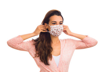 Beautiful young woman wearing a protective mask isolated on a white background
