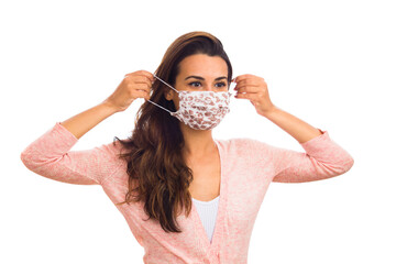 Beautiful young woman wearing a protective mask isolated on a white background