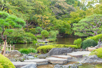Fototapeta na wymiar japanese garden with pond in tokyo, japan