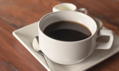 white ceramic cup of coffee on wooden table