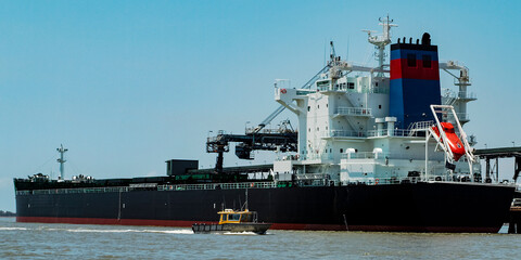 Fototapeta premium A 229 meter Bulk Carrier Ship loading at a Gladstone Harbour terminal. Queensland, Australia