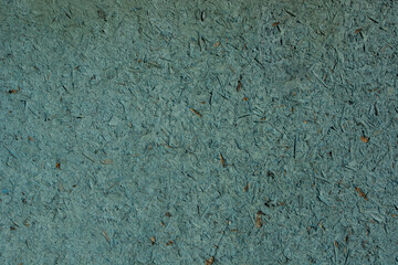 the texture of particle board painted blue