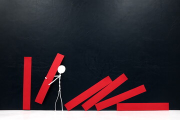 Stick man figure putting up fallen red dominos. Restart rebuild economy and business concept.	