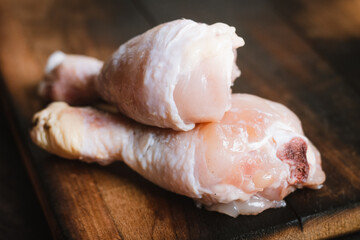 Raw chicken legs on cutting board