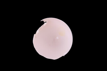 Cracked white chicken egg shell, bottom half, isolated on black background, closeup top view. White egg cracked open leaving shell empty inside. Concept for hatched ideas, plans, dreams or schemes.