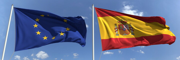Fototapeta premium Flying flags of the European Union and Spain on high flagpoles. 3d rendering