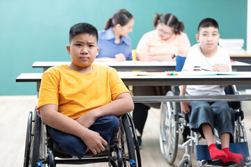 portrait asian disabled children(lost legs) sitting on a wheelchair in classroom